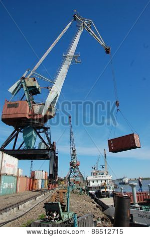 Dockside Cargo Crane With Container At River Port