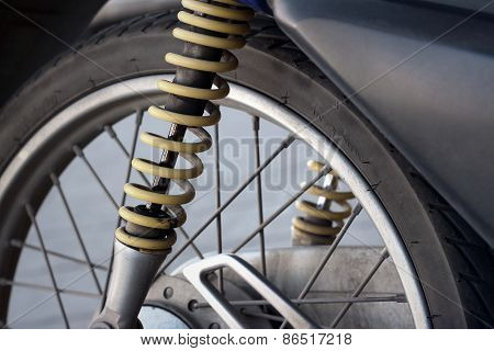 Shock Absorbers Of Yellow Motorcycles At The Park