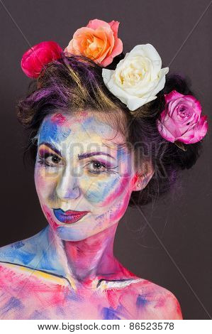 Model with colorful make-up and roses in hair.