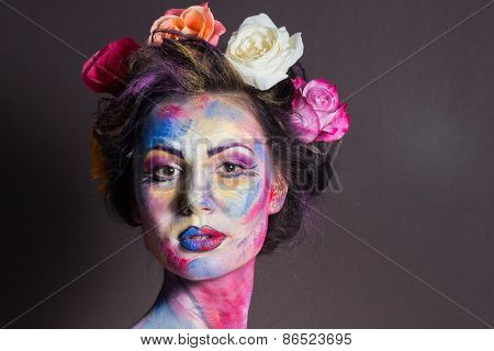 Model with colorful make-up and roses in hair.