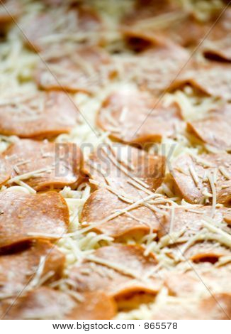 A Sheet Of Uncooked Pepperoni Pizza