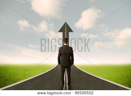 Businessman lokking at 3d road upgoing arrow concept