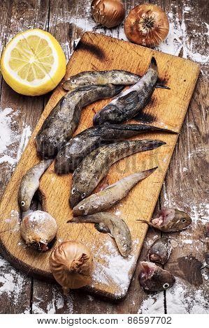 Fresh Fish Before You Cook It On A Chopping Board With Knife