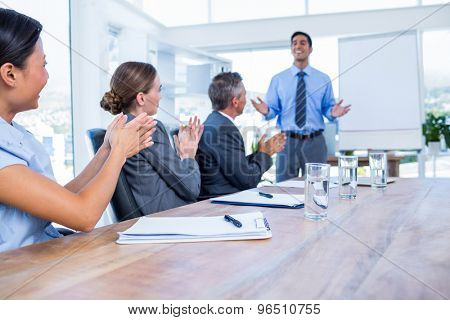 Business people applauding during a meeting in the office