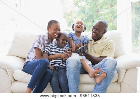 Happy smiling family on the couch in the living room