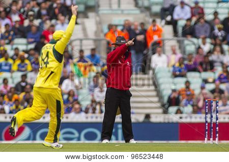 LONDON, ENGLAND - June 17 2013: Umpire  Tony Hill  signals out for Sri Lanka's Kusal Perera of the bowling of Mitchell Johnson during the ICC Champions Trophy match between Sri Lanka and Australia.