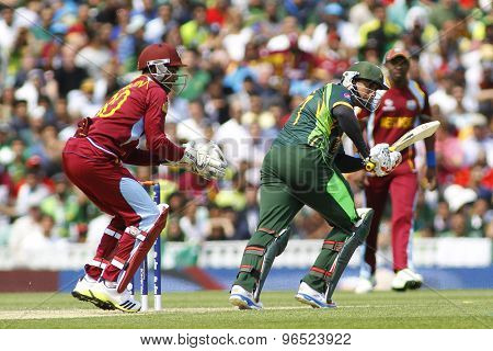 LONDON, ENGLAND - June 07 2013: West Indies Denesh Ramdin and Pakistan's Nasir Jamshed during the ICC Champions Trophy cricket match between Pakistan and The West Indies at The Oval Cricket Ground.