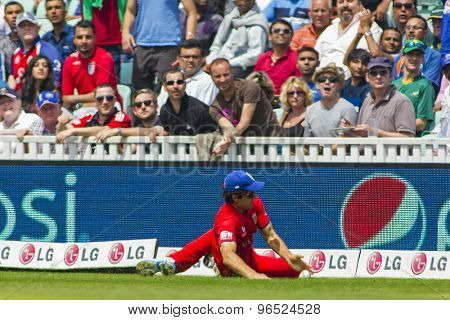 LONDON, ENGLAND - June 19 2013: England's captain Alastair Cook saves a boundary during the ICC Champions Trophy semi final match between England and South Africa at The Oval Cricket Ground