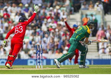 LONDON, ENGLAND - June 19 2013: England's Jos Buttler catches the ball to dismiss Chris Morris during the ICC Champions Trophy semi final between England and South Africa at The Oval Cricket Ground