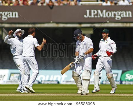 LONDON, ENGLAND. AUGUST 20 2012 England's Jonathan Trott walks off as South Africa celebrate during the third Investec cricket  test match between England and South Africa, at Lords Cricket Ground