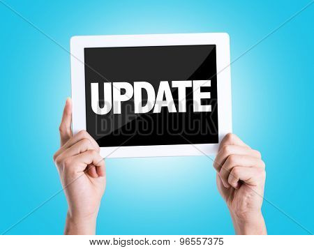 Tablet pc with text Update with blue background