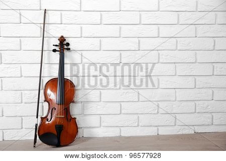 Violin on bricks wall background