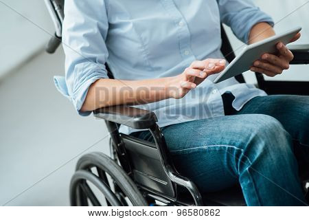 Woman In Wheelchair Using A Tablet