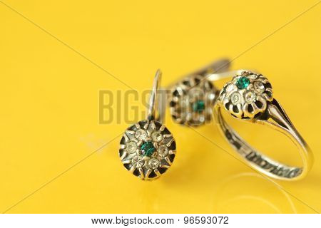 Women's earrings and a ring of white metal and green stones