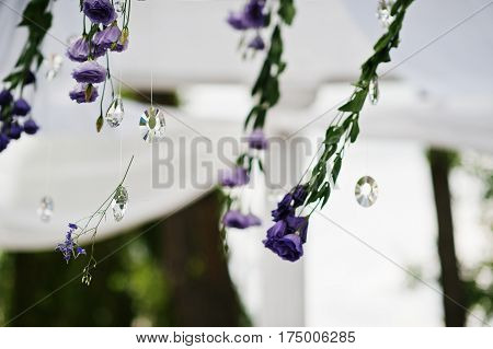Decoration Of Wedding Arch With Violet And Purple Flowers And Diamods.