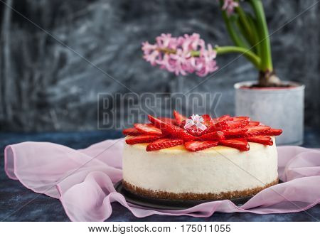 Delicious cheese cake decorated with fresh strawberries