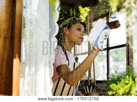 African Descent Woman Cleaning Wiping Shop Glass