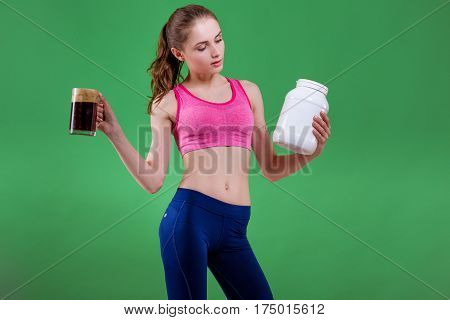 Caucasian girl that chooses to drink beer or eat of sports nutrition. Choice concept.