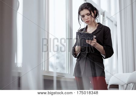 Beautiful business woman with a clipboard in office
