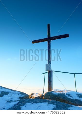 Winter Mountain. Wooden Cross On Rocky Mountain Summit.
