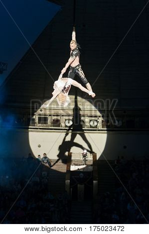 Stunt aerialists men and women in the circus. Love, danger, and romance concept.