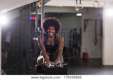 young fit african american woman doing sit ups in fitness studio at the gym.Abdominal exercises Sit up