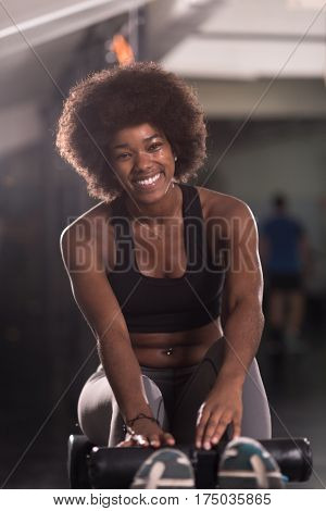 young fit african american woman doing sit ups in fitness studio at the gym.Abdominal exercises Sit up