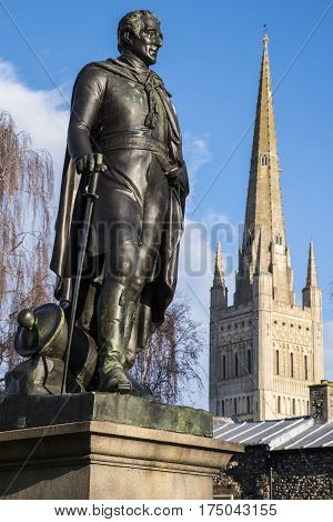 A statue of the Duke of Wellington with the beautiful Norwich Cathedral in the background in the historic city of Norwich UK.