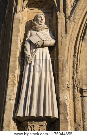 A sculpture of Mother Julian on the exterior of the West Porch of Norwich Cathedral in the historic city of Norwich UK.