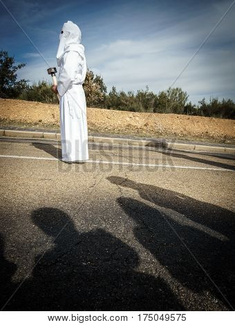 Tourist shadows enjoying easter traditional procession in bercianos de aliste brotherhood, zamora, Spain