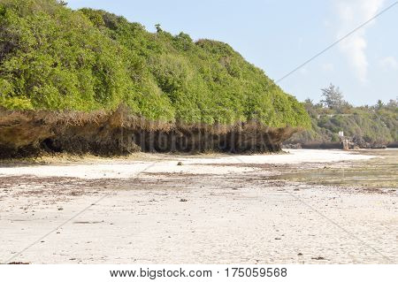 Small cove with a rock on the white sand of the bamburi beach in Mombasa Kenya