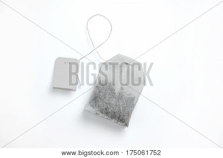 Teabag with yellow label. Top view. Isolated on a white.