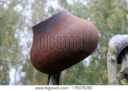 Cooking pot on the pole of the fence