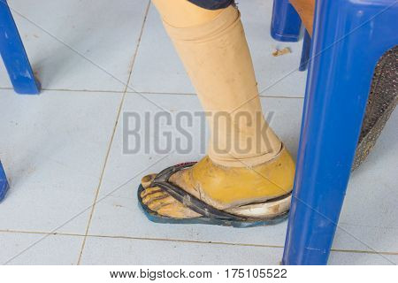 closeup asian old woman with wooden prostheses