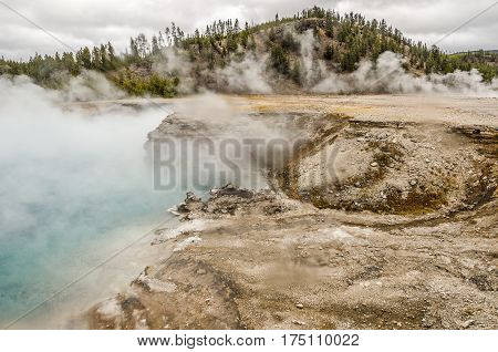 Excelsior Geyser emerging from the steamy mist at Midway Geyser Basin in Yellowstone National Park