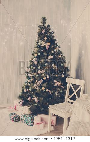 Christmas toys on a Christmas tree under snow