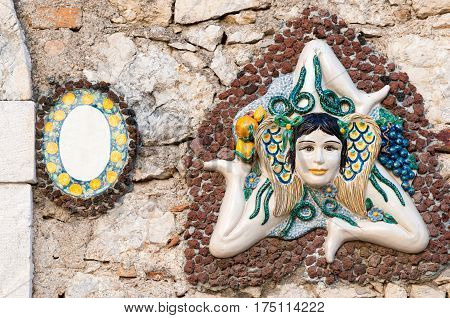 A typical ceramic Trinacria the symbol of Sicily hung along the streets of Taormina