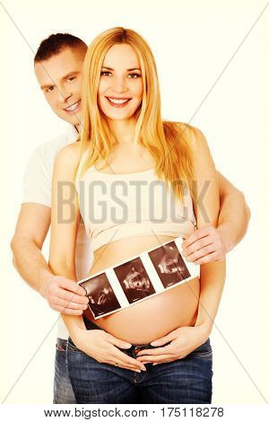 Couple holding usg scan of their baby