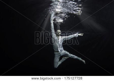 A Young Male Ballet Dancer Posing Underwater