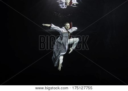 A Young Male Ballet Dancer Posing Underwater