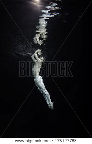 A Young Male Ballet Dancer Posing Underwater