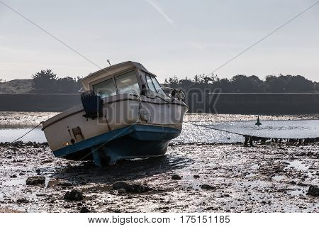Boat at low tide in the Saint-Gilles Croix de Vie harbour (France)
