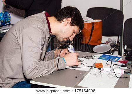 Moscow, Russia - November, 2016: Man using 3D printing pen