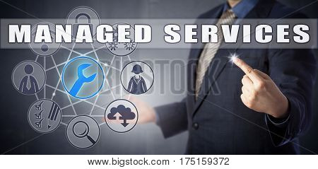 Male outside consultant in blue business suit is presenting a MANAGED SERVICES concept. Information technology and business metaphor for outsourcing IT functions to remote service provider companies.