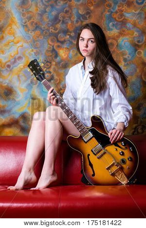 Podolsk, Russia - February 21, 2017: Young brunette girl with a vintage electric guitar Gibson es-345 1969 model year