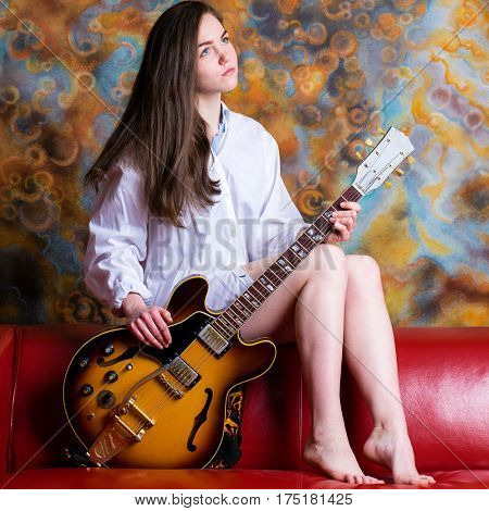Podolsk, Russia - February 21, 2017: Young brunette girl with a vintage electric guitar Gibson es-345 1969 model year
