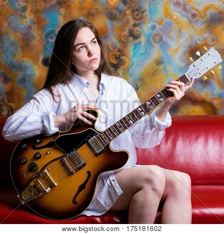 Podolsk, Russia - February 21, 2017: Young brunette girl with a vintage electric guitar Gibson es-345 1969 model year