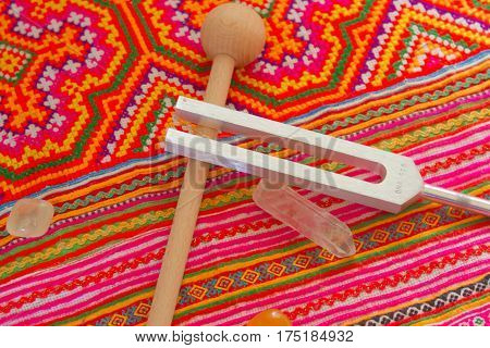 tuning fork and crystal on table .