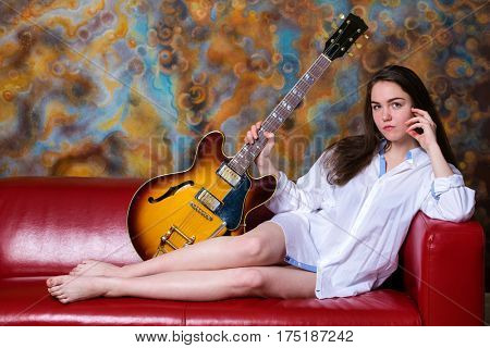 Podolsk, Russia - February 21, 2017: Young brunette girl with a vintage electric guitar Gibson es-345 1969 model year