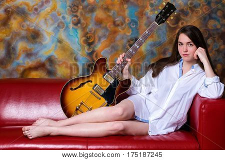 Podolsk, Russia - February 21, 2017: Young brunette girl with a vintage electric guitar Gibson es-345 1969 model year